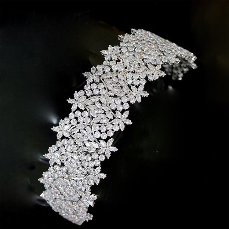 Silver bracelet with floral design on a dark background