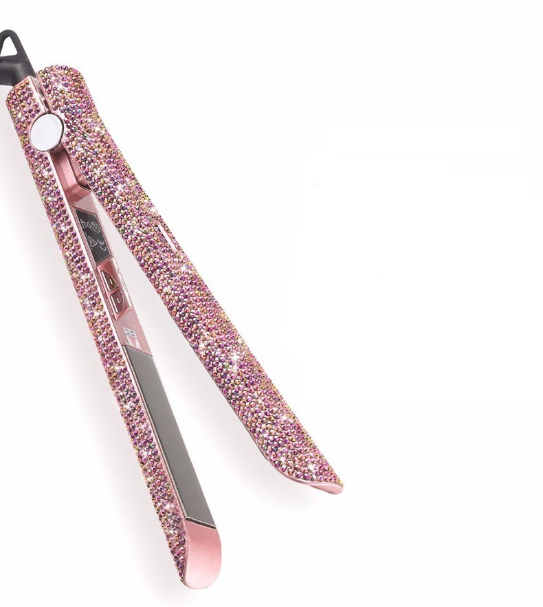 Pink hair straightener with rhinestone embellishments on a white background