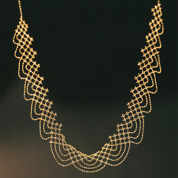 Gold necklace on a black background
