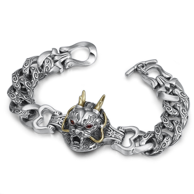 Silver bracelet with dragon design on a white background