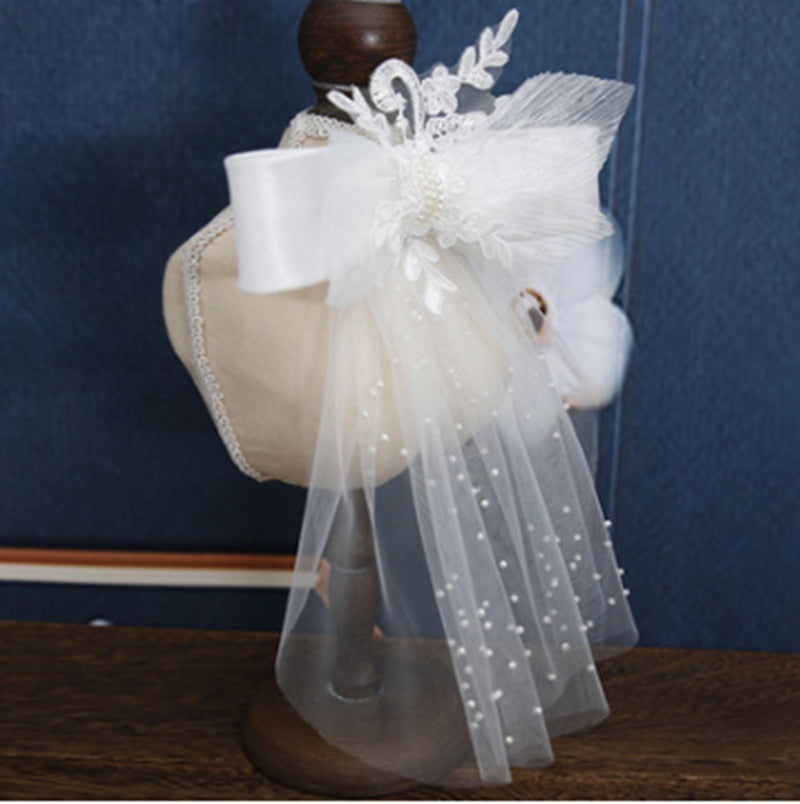 White horse head with decorative veil on a wooden stand against a blue background
