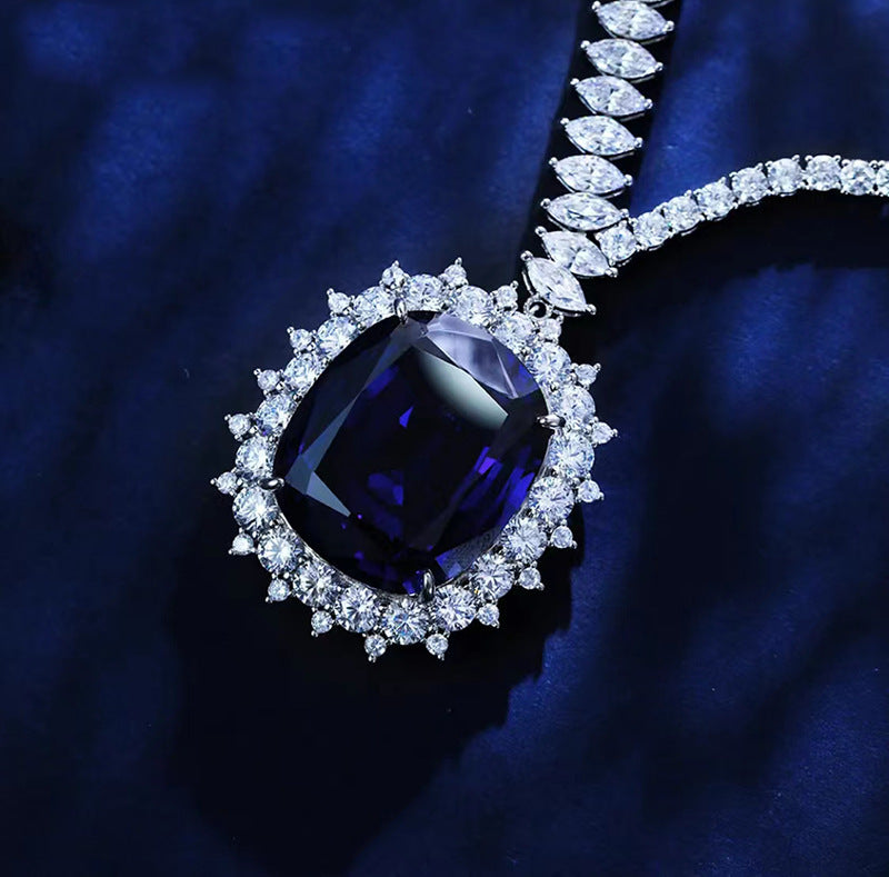 Diamond necklace with a large blue gemstone on a dark blue background