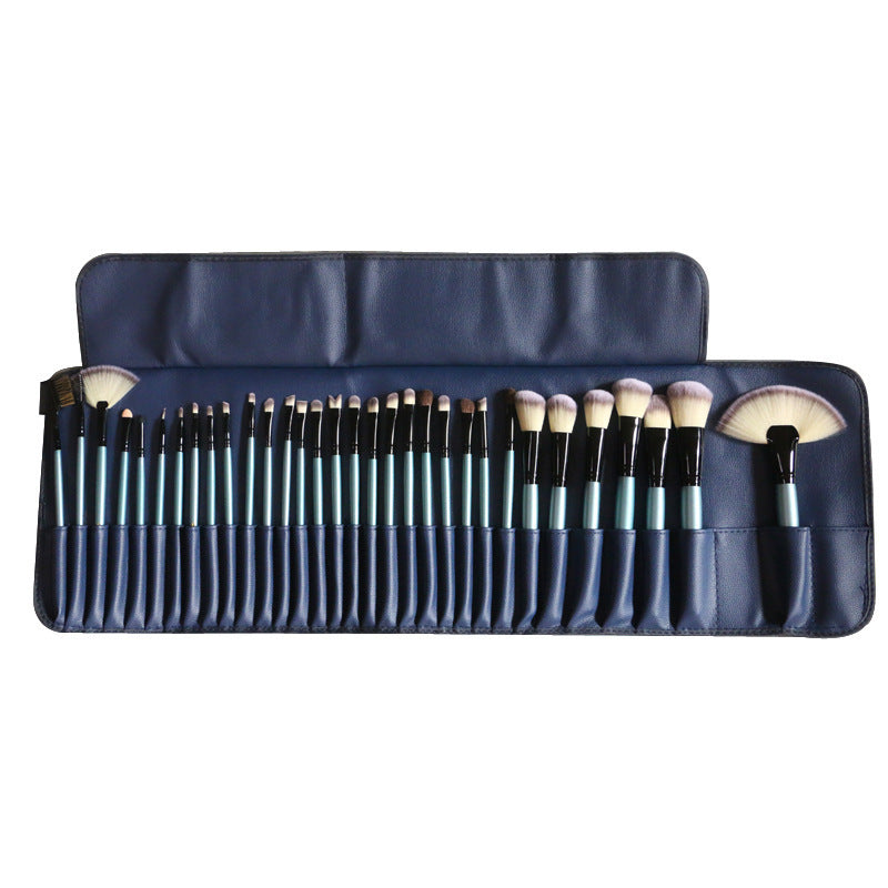 Set of makeup brushes in a navy blue case on a white background