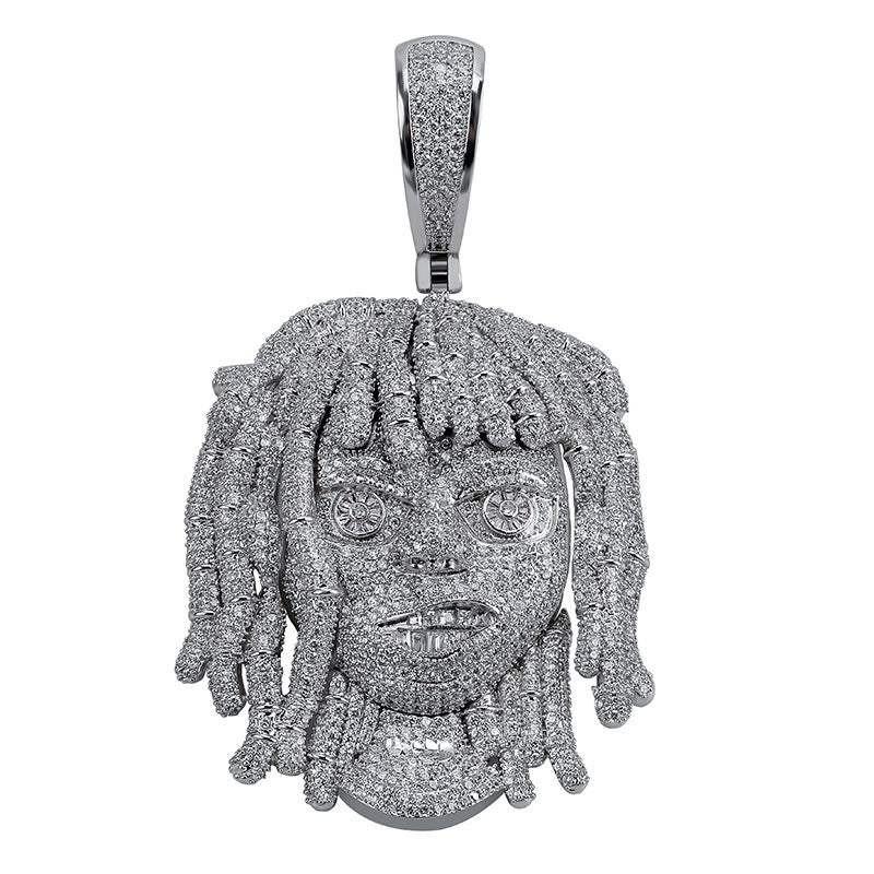Silver pendant with intricate detailing on a white background