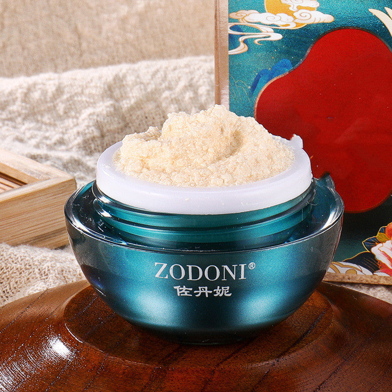 Blue jar of Zodoni cream with a decorative box in the background