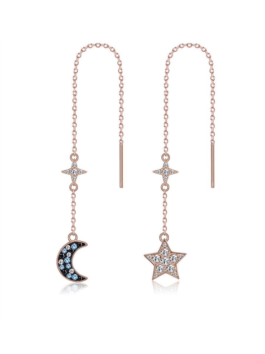 Rose gold threader earrings with star and moon charms on a white background