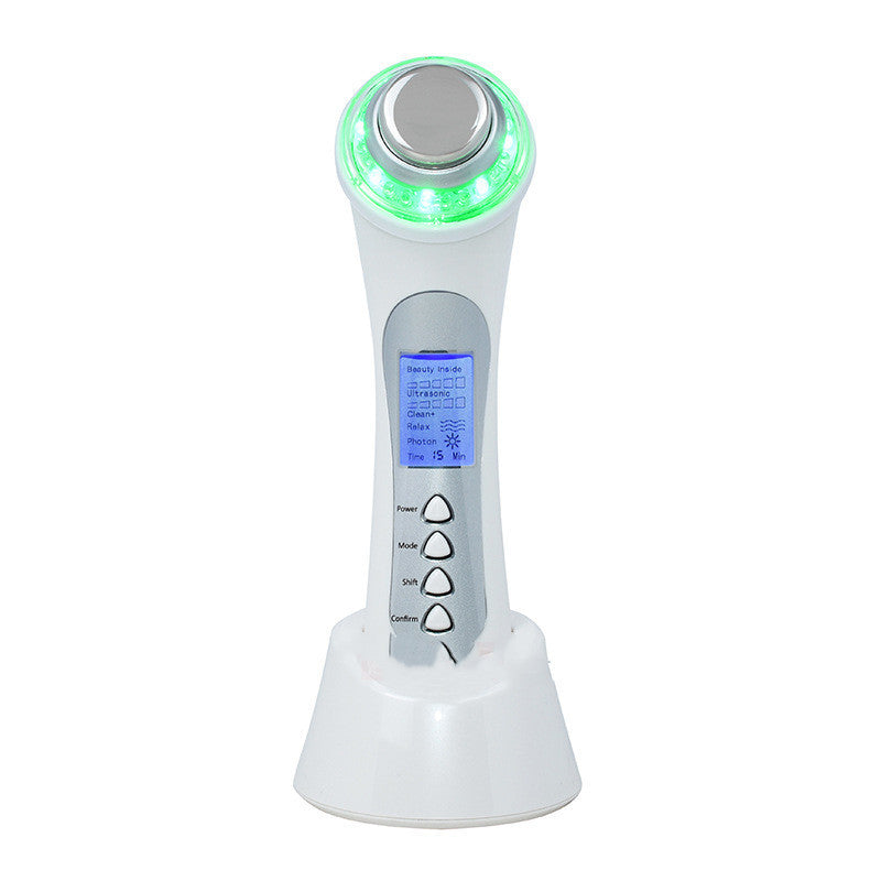 White electronic device with green light on top and digital display on a white background