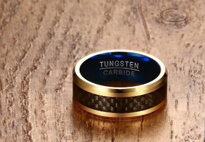 Gold ring with blue interior on a wooden background