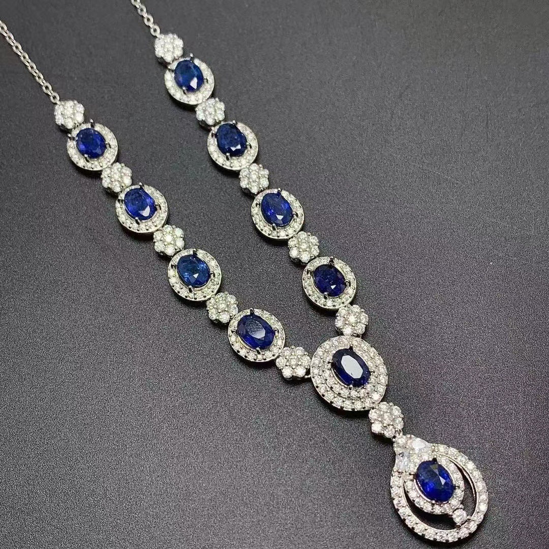 Elegant necklace with blue gemstones and silver accents on a dark background