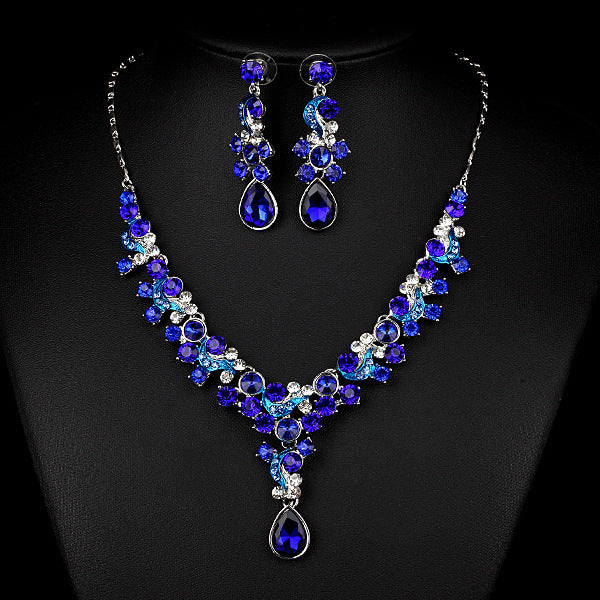 Blue gemstone necklace and earrings on a black background