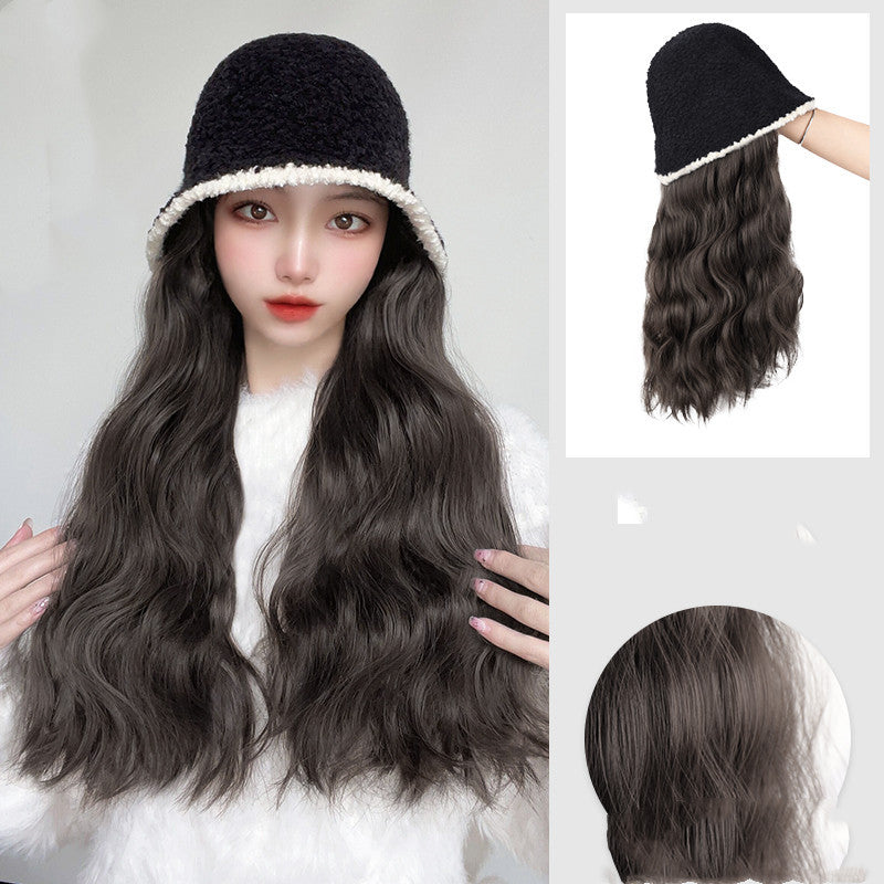 Person wearing a black bucket hat with a hair extension, showing close-up details of the hair product.