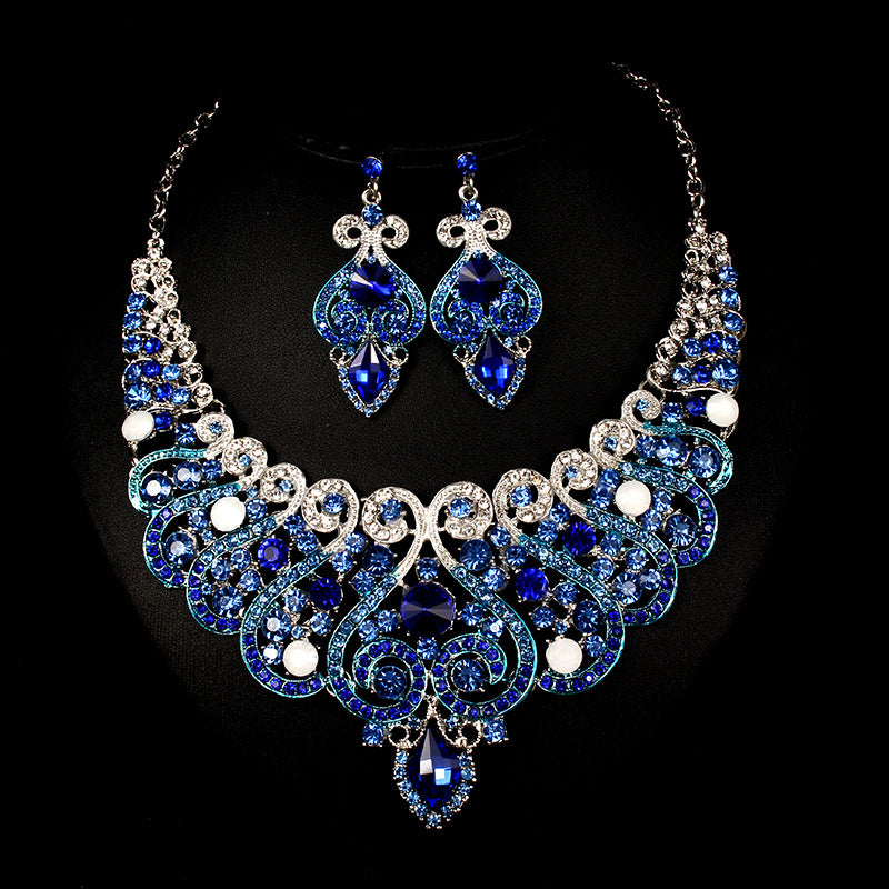 Blue and silver jewelry set with necklace and earrings on a black background