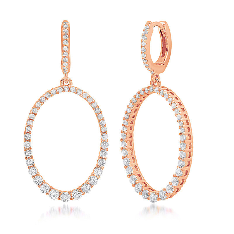 Rose gold hoop earrings with diamond accents on a white background