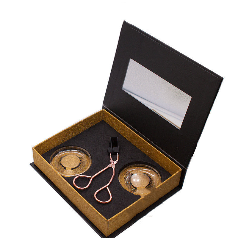 Set of earrings in a black and gold box on a white background