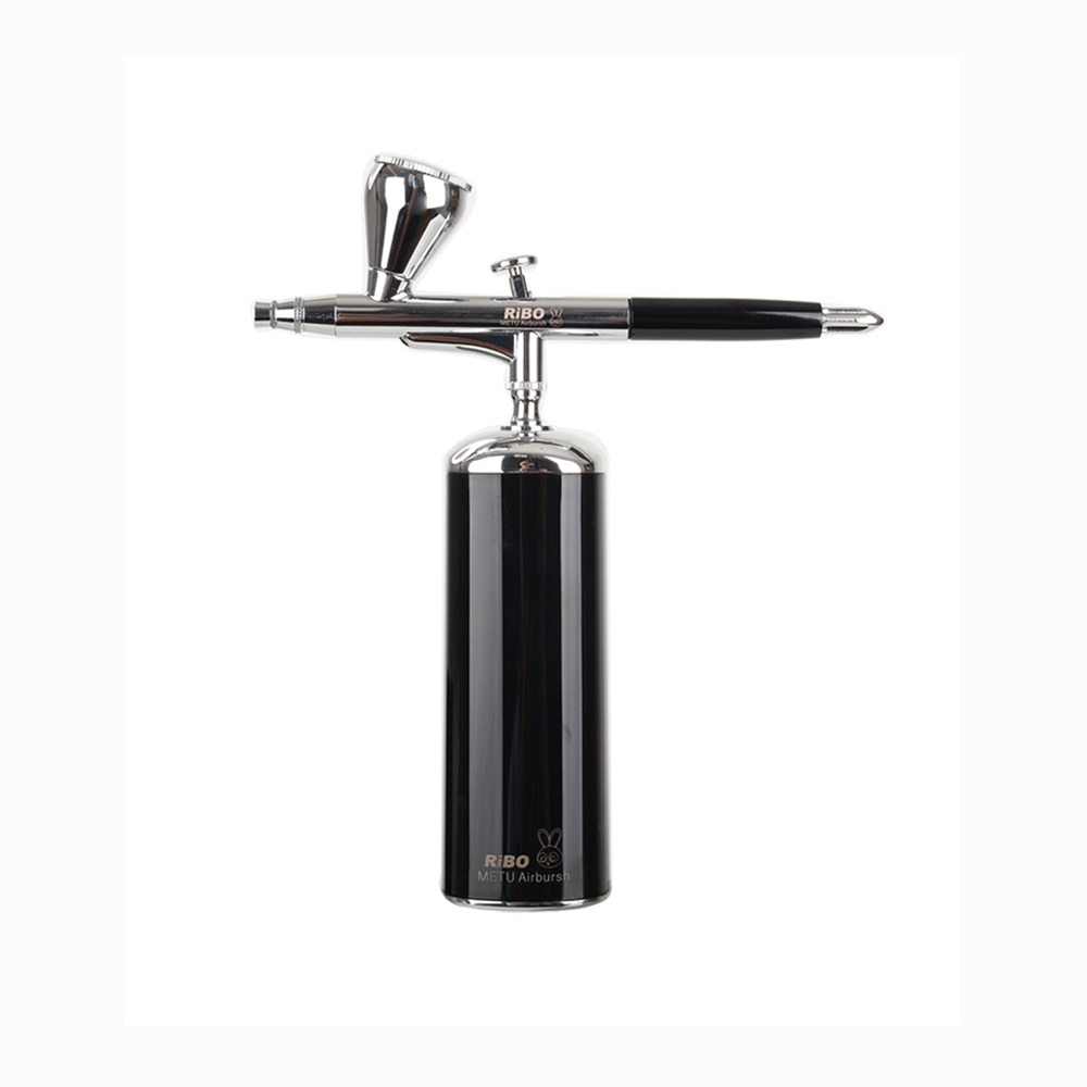 Black and silver airbrush gun on a white background