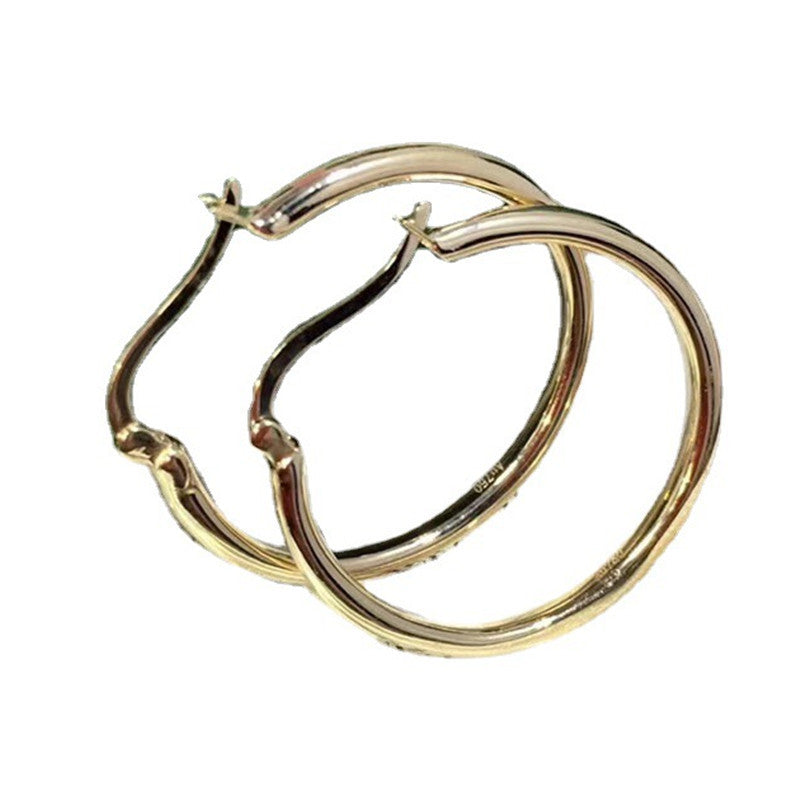 Gold hoop earrings on a white background