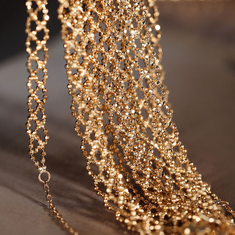 Close-up of a gold chain with a blurred background