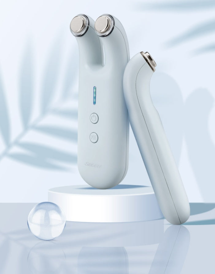 White electronic device with silver accents on a light blue background