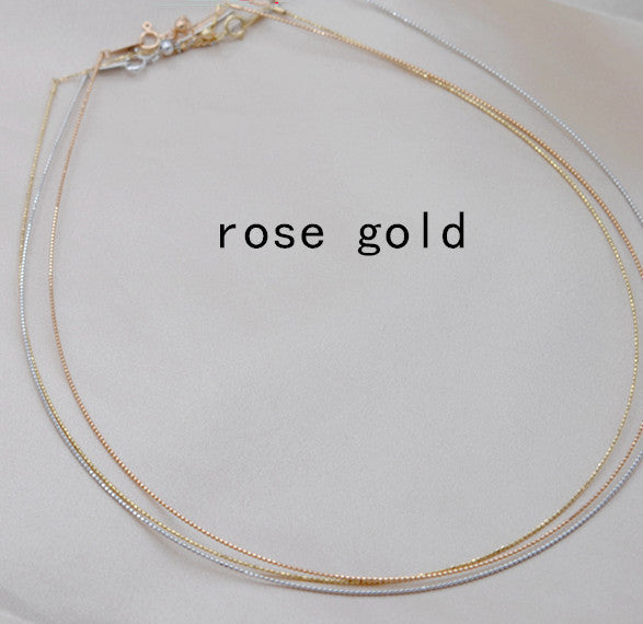 Rose gold necklace on a light gray background with 'rose gold' text.