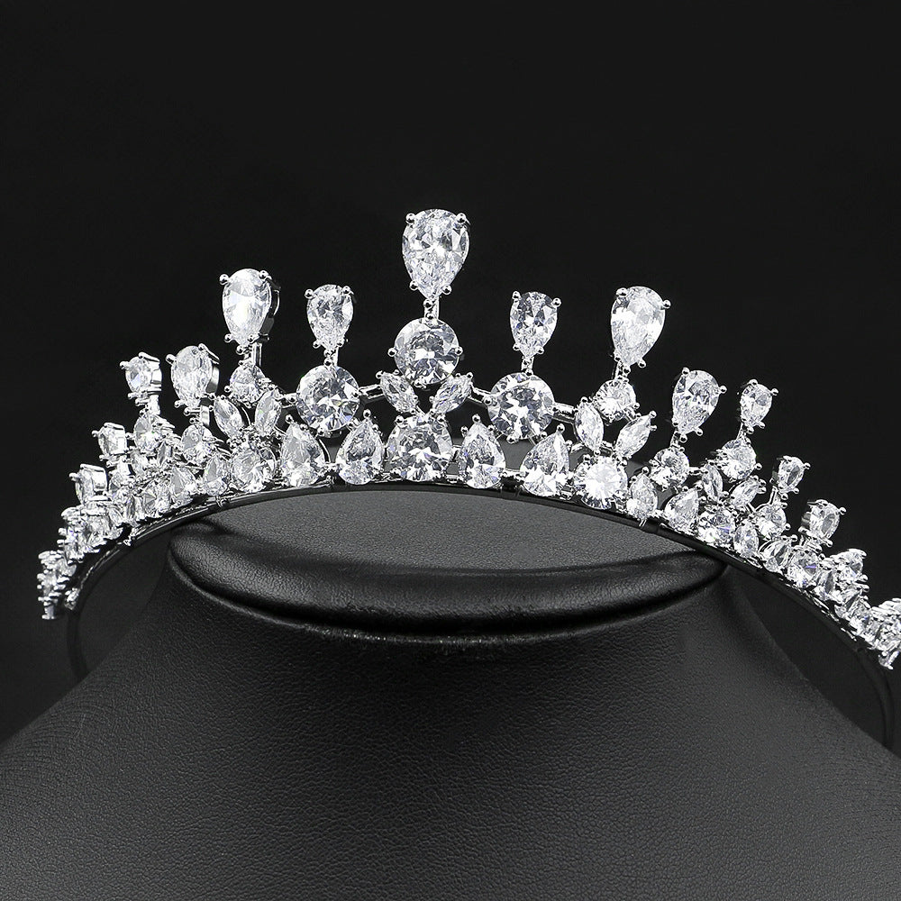 Diamond tiara on a black stand against a black background