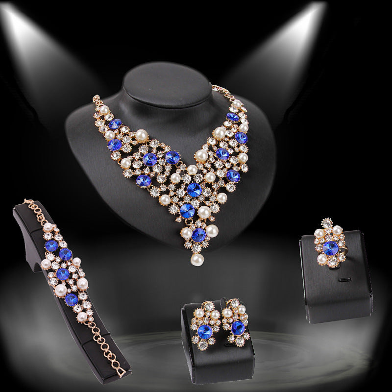 Jewelry set with necklace, bracelet, and earrings on a black background
