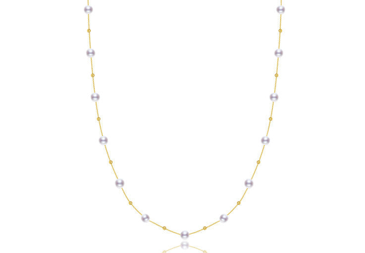 Pearl necklace with gold chain on a white background