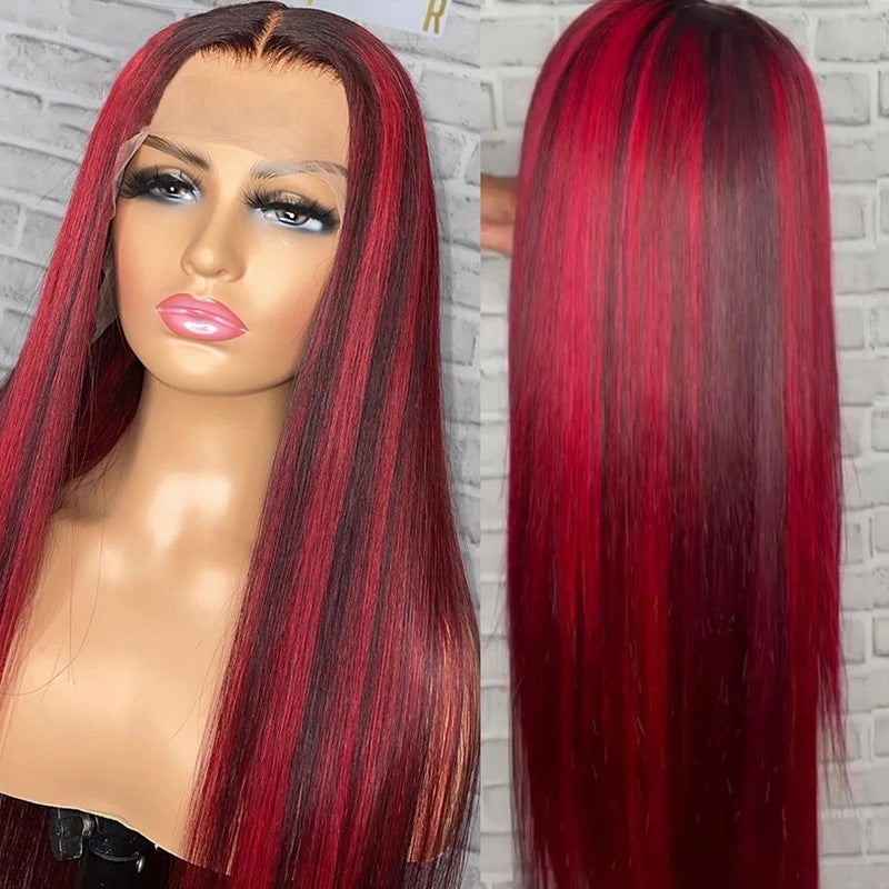 Red and black ombre wig on a mannequin head with a brick wall background