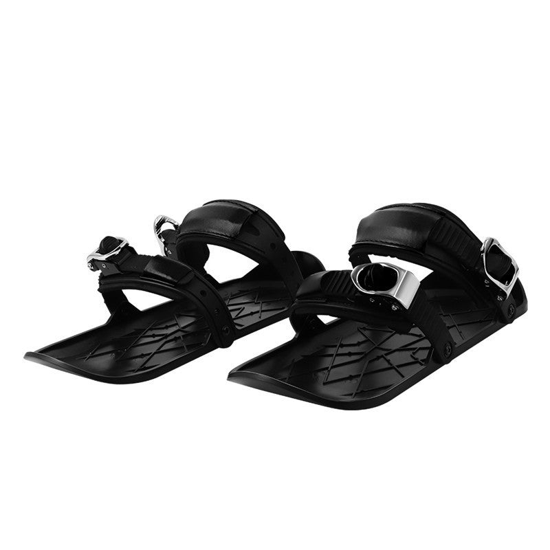 Black sandal with metallic buckle on a white background
