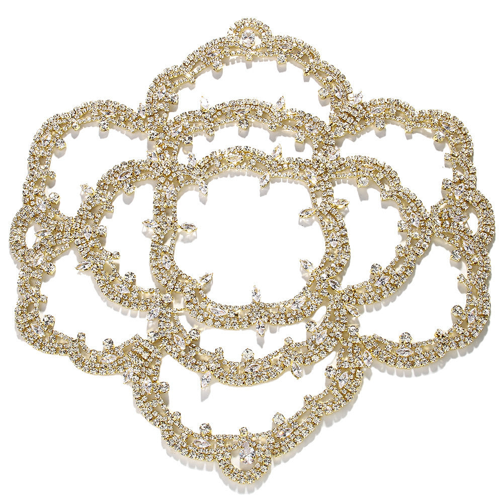 Decorative gold brooch with intricate design on a white background