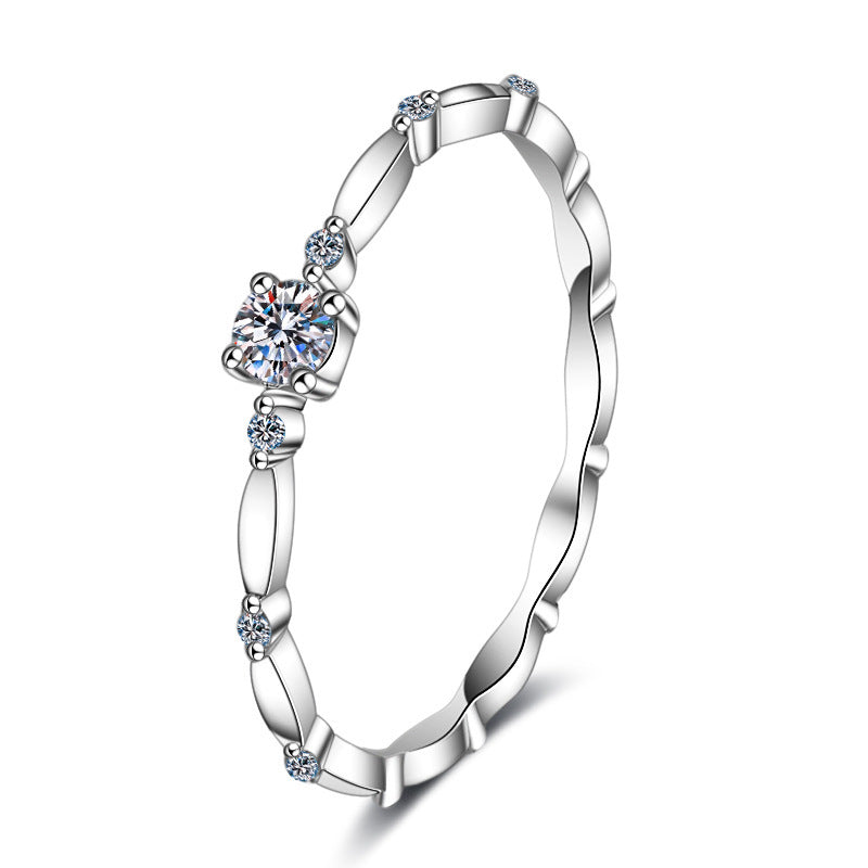 Silver ring with heart-shaped gemstone on a white background