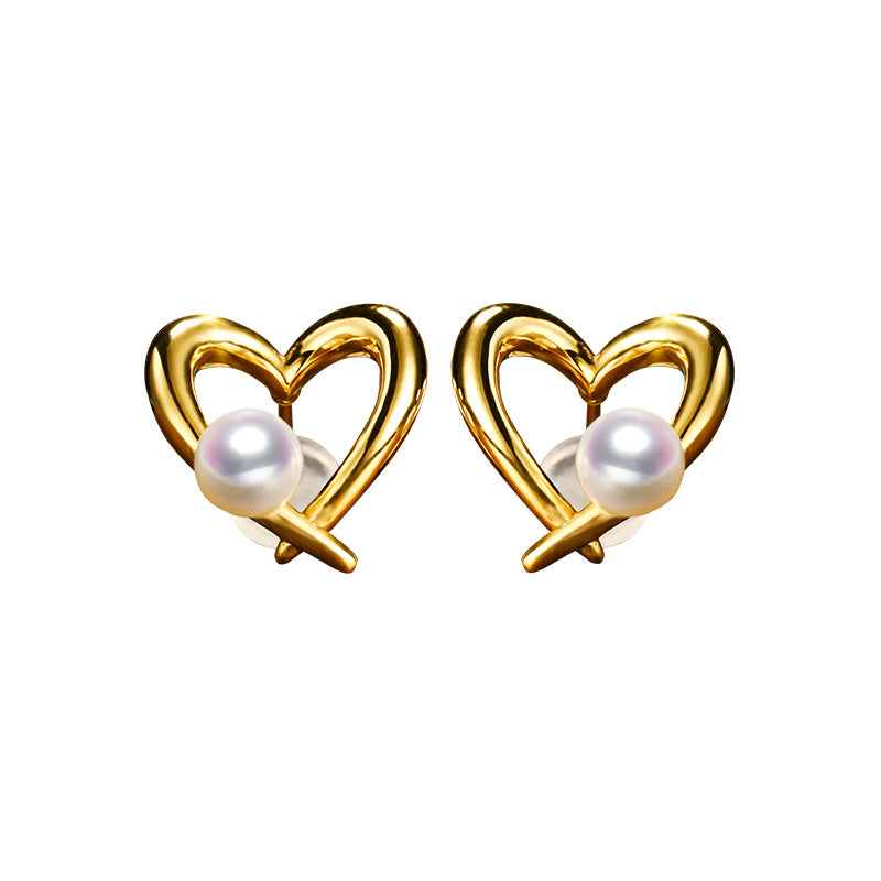 Gold heart-shaped earrings with pearls on a white background
