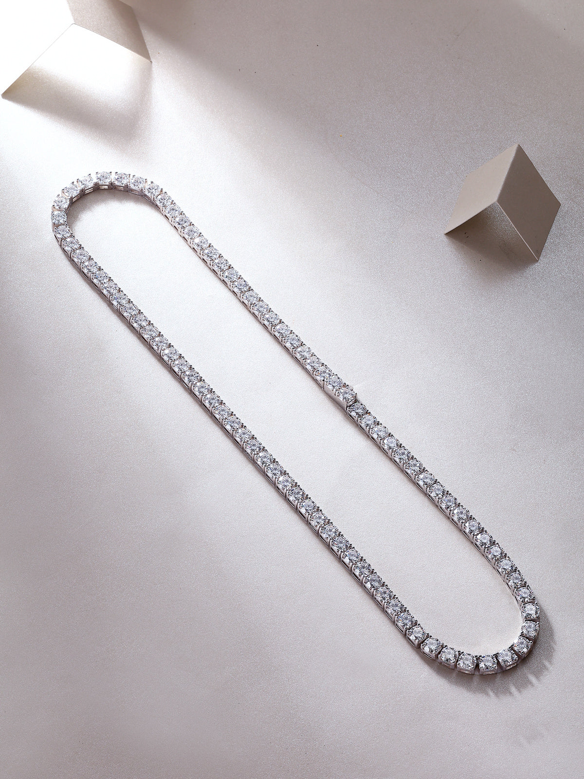 Diamond tennis necklace on a light gray background