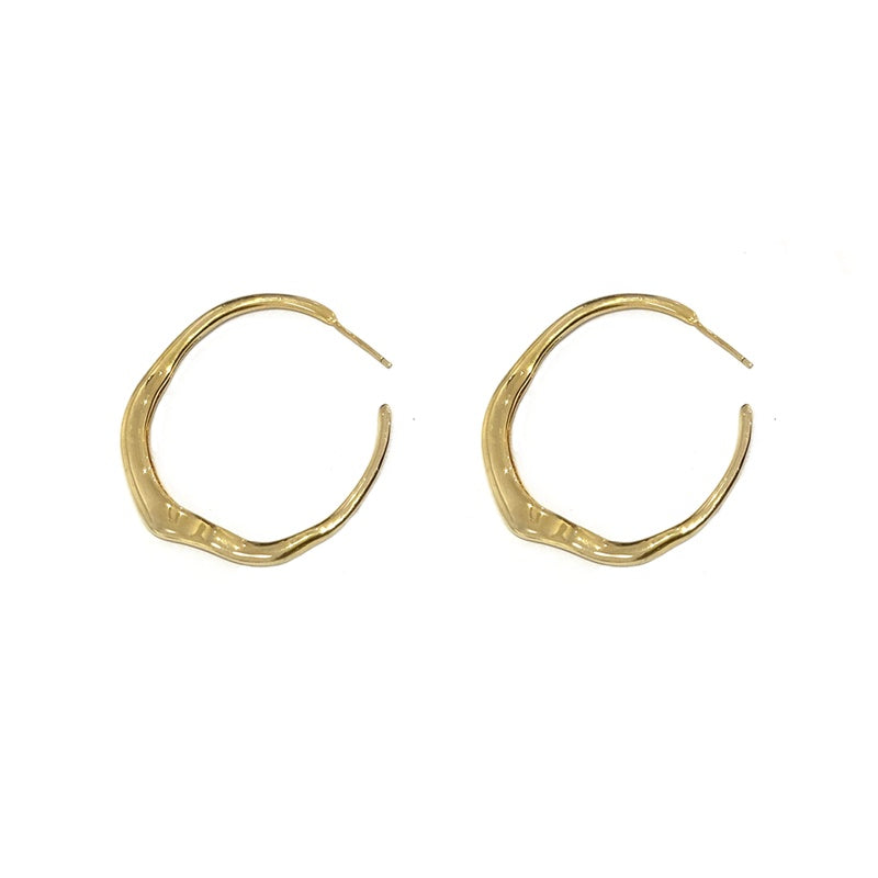 Gold hoop earrings on a white background