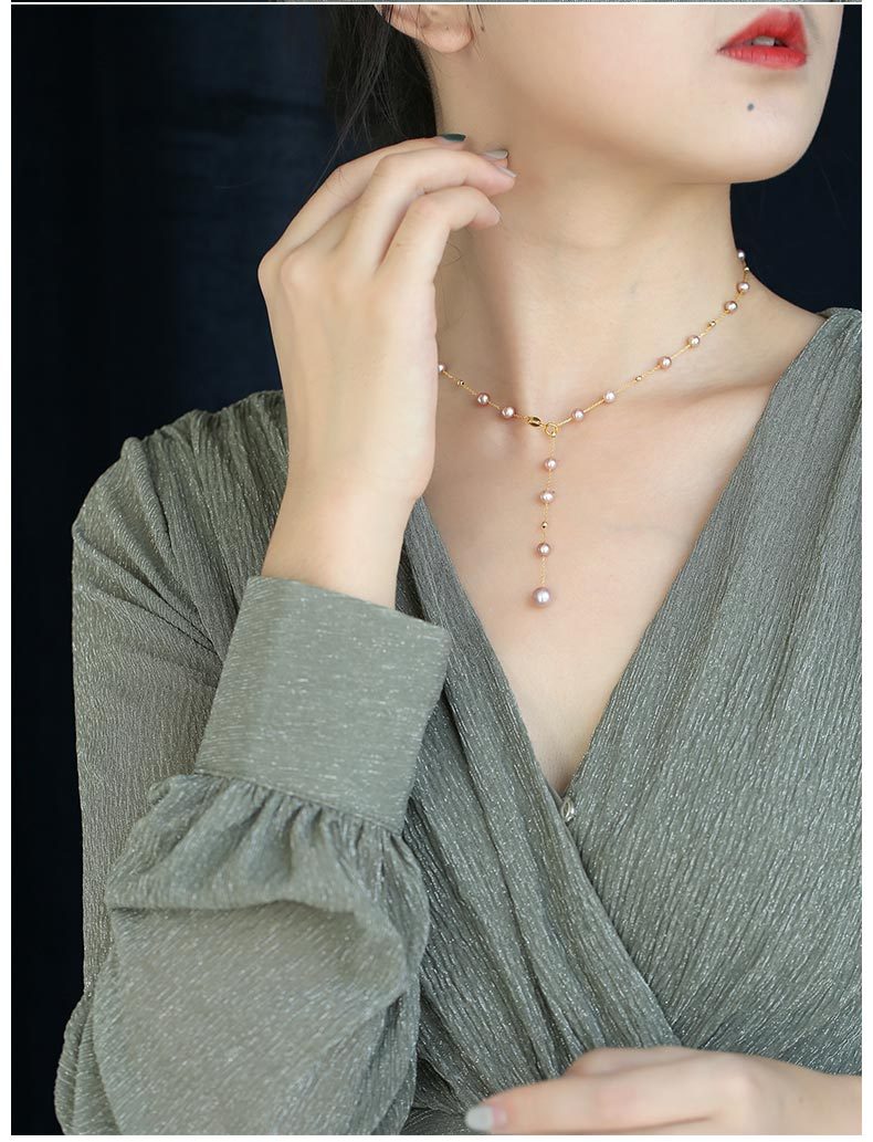 Woman wearing a pearl necklace with a plain background