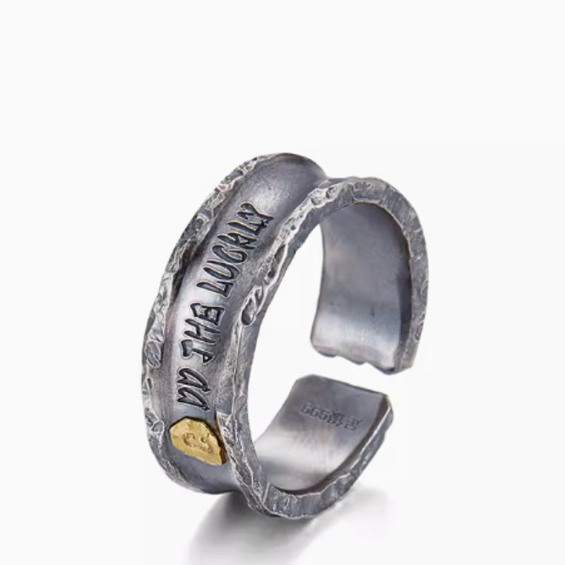 Silver cuff bracelet with engraved text on a white background