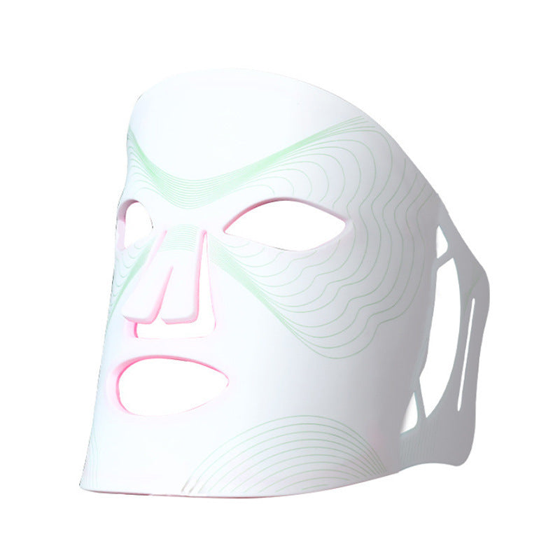 White face mask with pink and green accents on a white background