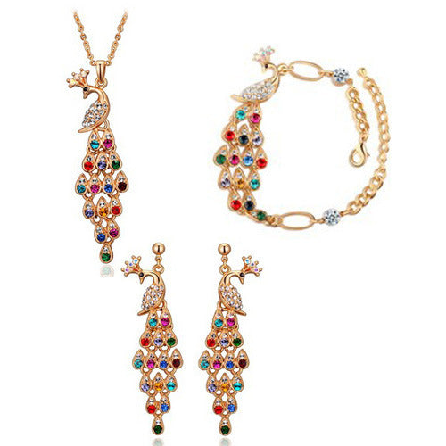 Jewelry set with peacock design necklace, earrings, and bracelet on a white background