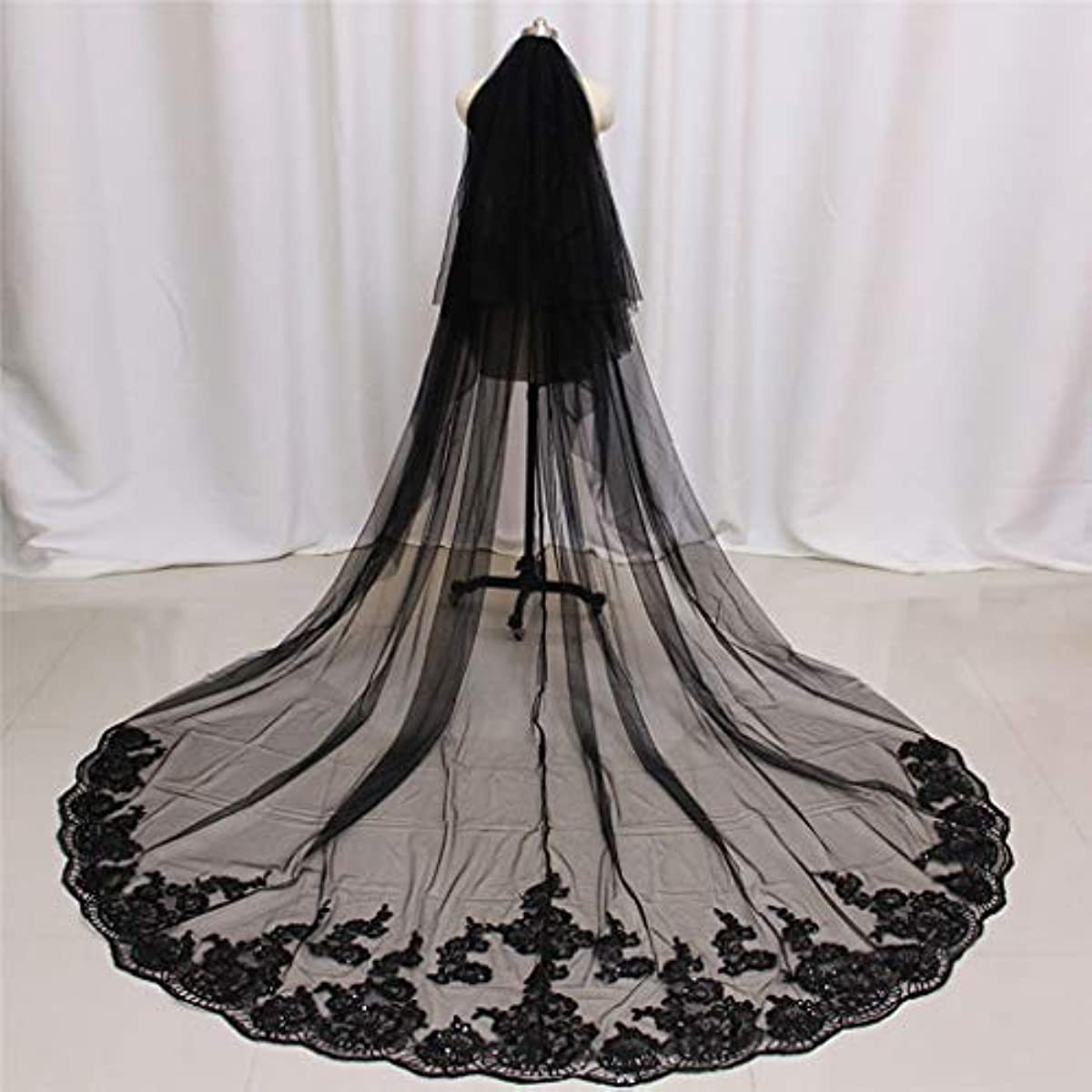 Black wedding veil with floral lace details on a white background