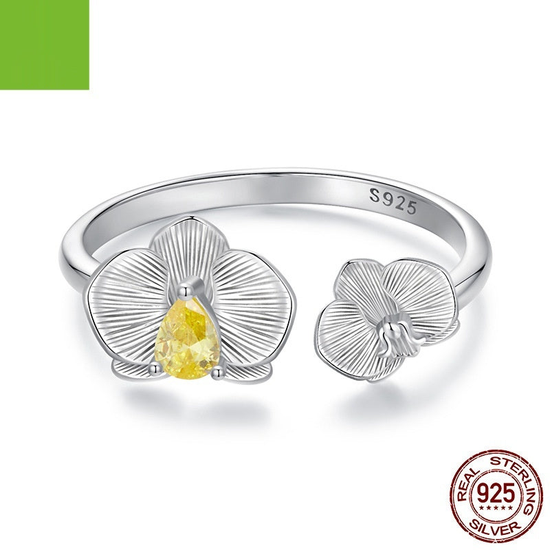 Silver ring with a yellow gemstone and '925' stamp on a white background