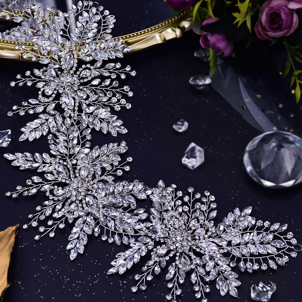 Decorative crystal hairpiece on a dark surface with decorative elements.