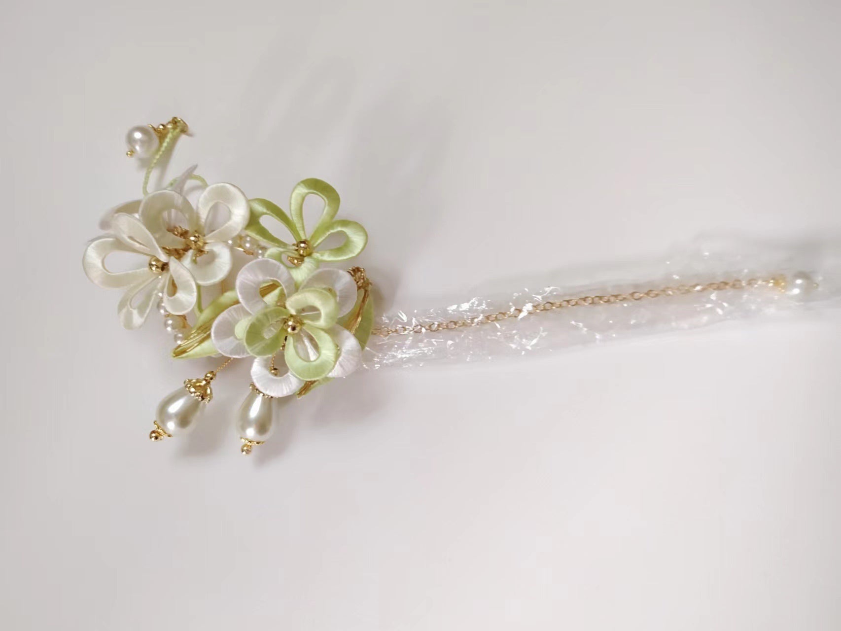 Floral hairpin with pearls on a light gray background