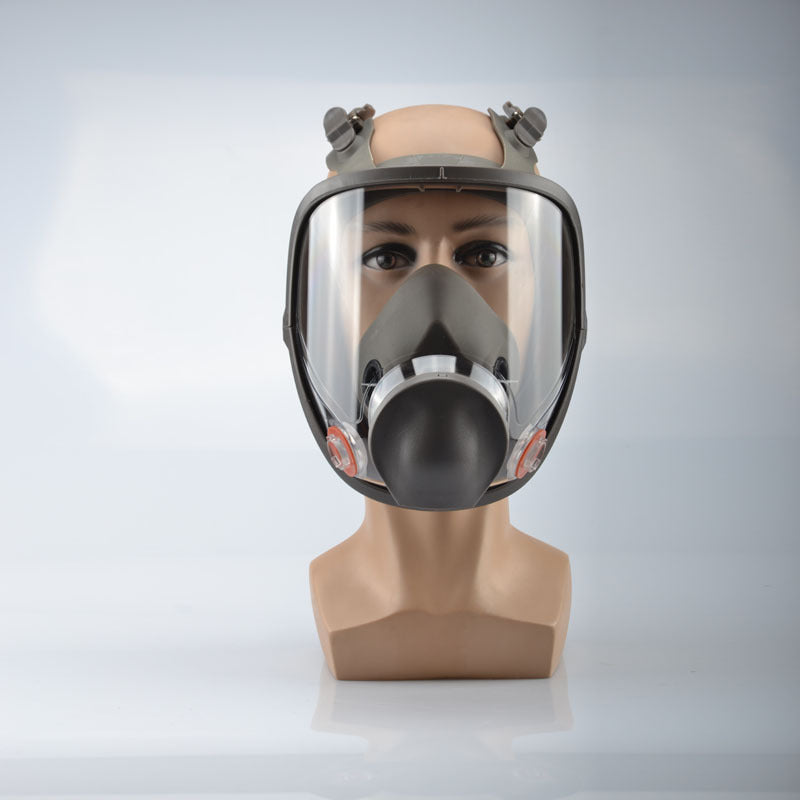 Full-face safety mask on a mannequin head against a gray background