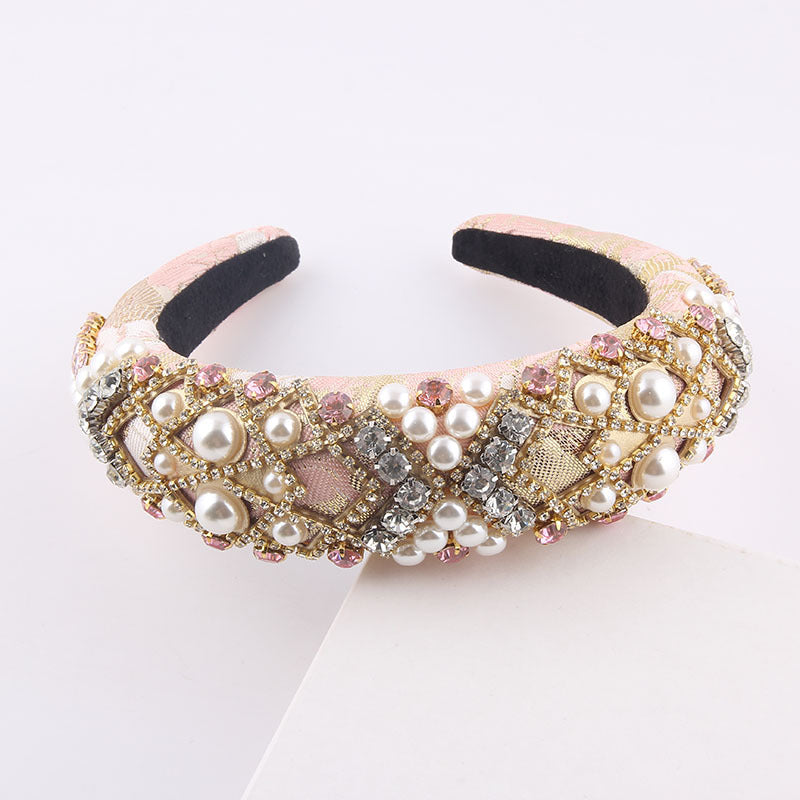 Decorative headband with pearls and crystals on a white background