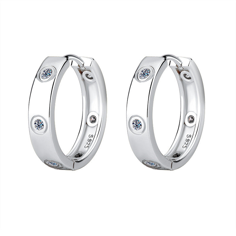 Pair of silver hoop earrings with embedded diamonds on a white background