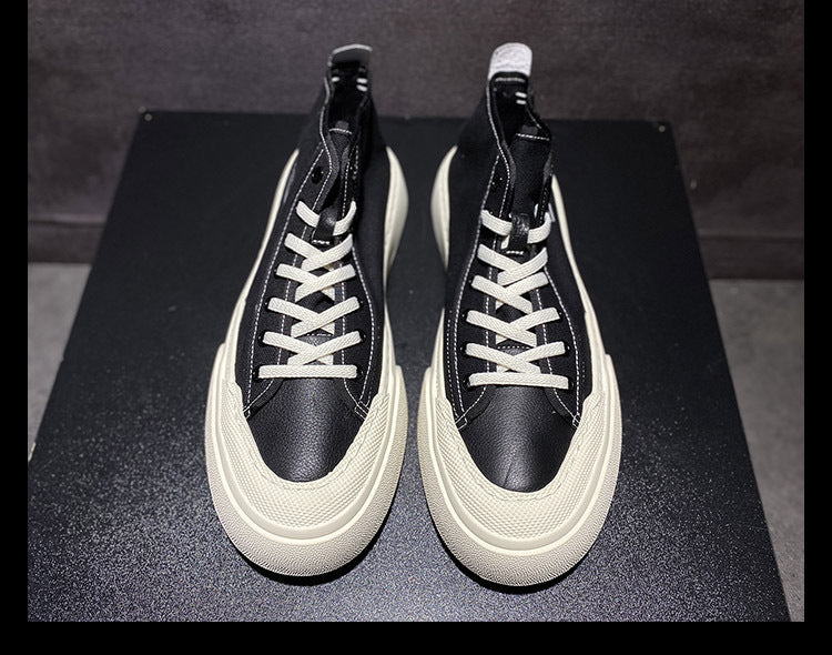 Black high-top sneakers with white soles on a black platform