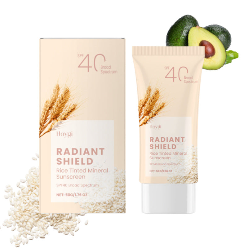 Radiant Shield Rice Tinted Mineral Sunscreen with packaging and avocados on a white background