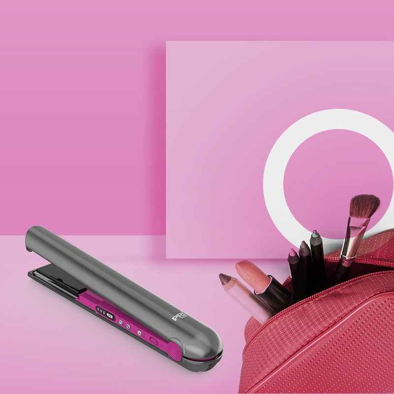 Beauty tools including a hair straightener, makeup brushes, and a pink case on a pink background