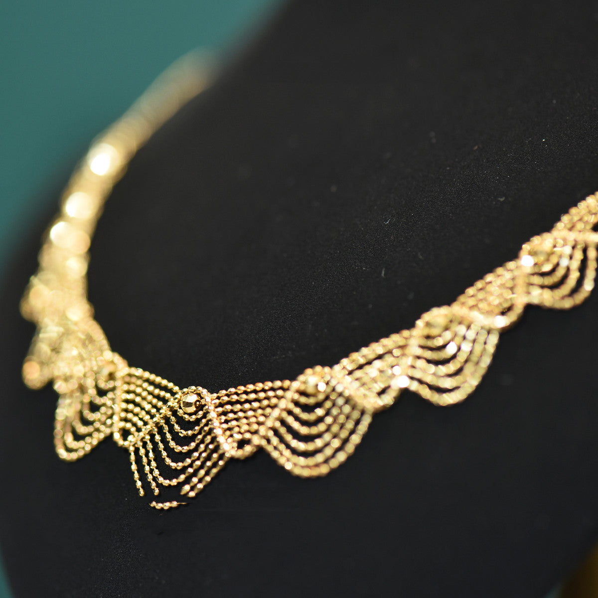 Gold necklace on a black background