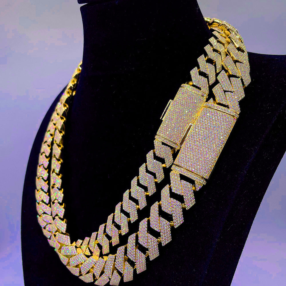 Gold and diamond-encrusted necklace on a black mannequin against a gradient background