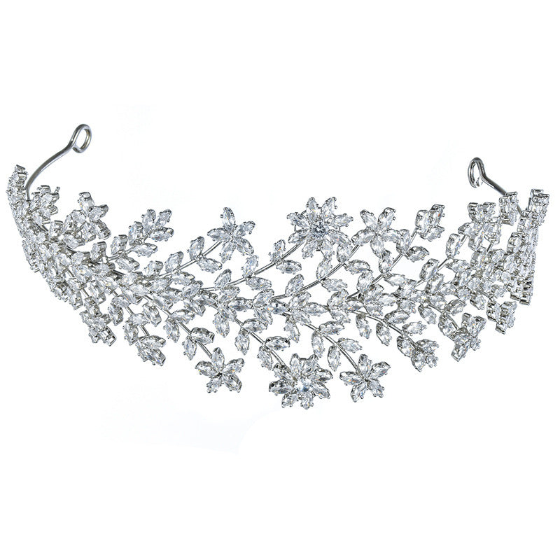 Silver tiara with floral design on a white background